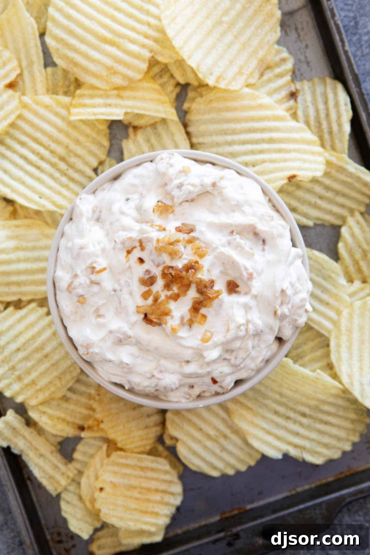 A bowl of rich, homemade French Onion Dip, beautifully topped with extra caramelized onions, ready to be enjoyed.