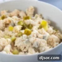 Briny Burst Pasta Salad 8 Serving bowl filled with Dill Pickle Pasta Salad topped with chopped pickles.