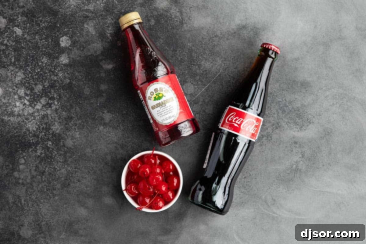 The essential ingredients laid out for preparing a classic Roy Rogers Drink: grenadine, cola, and maraschino cherries.