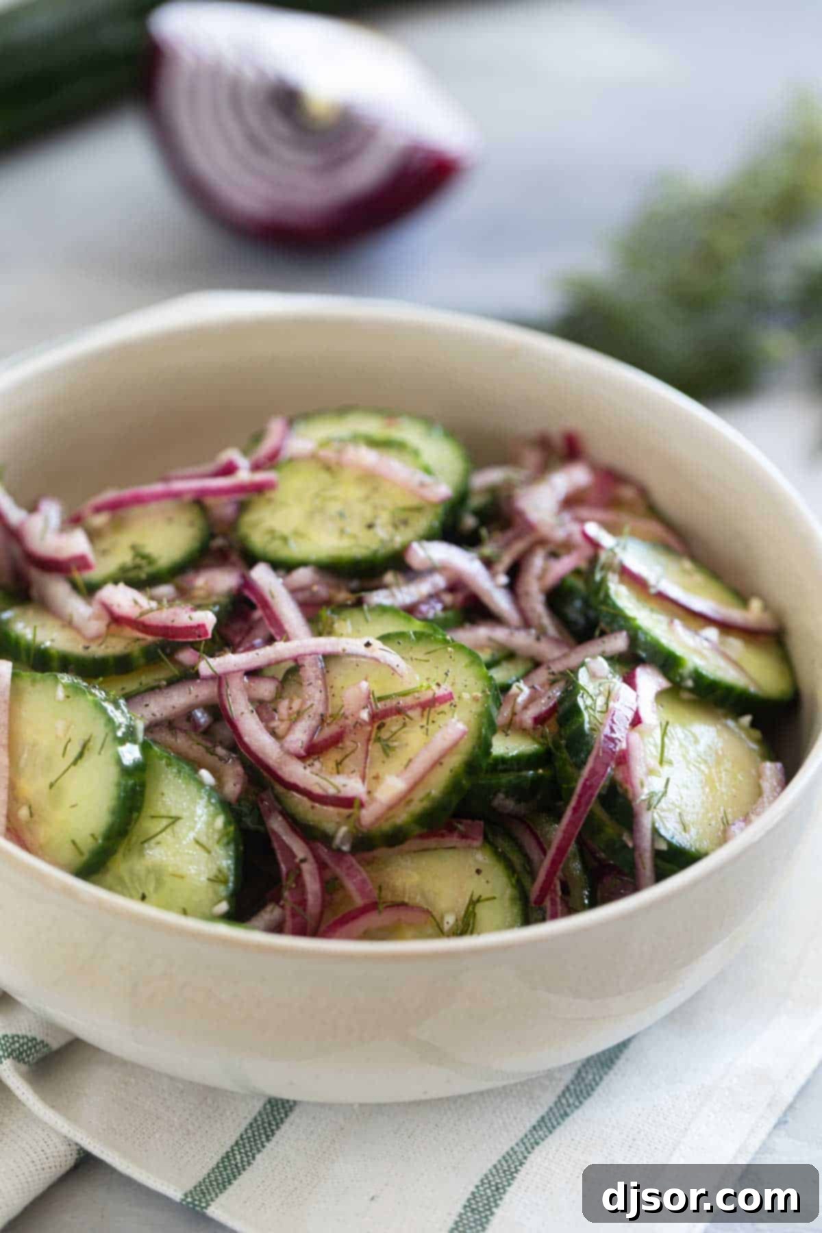 Refreshing Cucumber and Onion Salad 2 Bowl with Cucumber Onion Salad with fresh dill and salt and pepper.