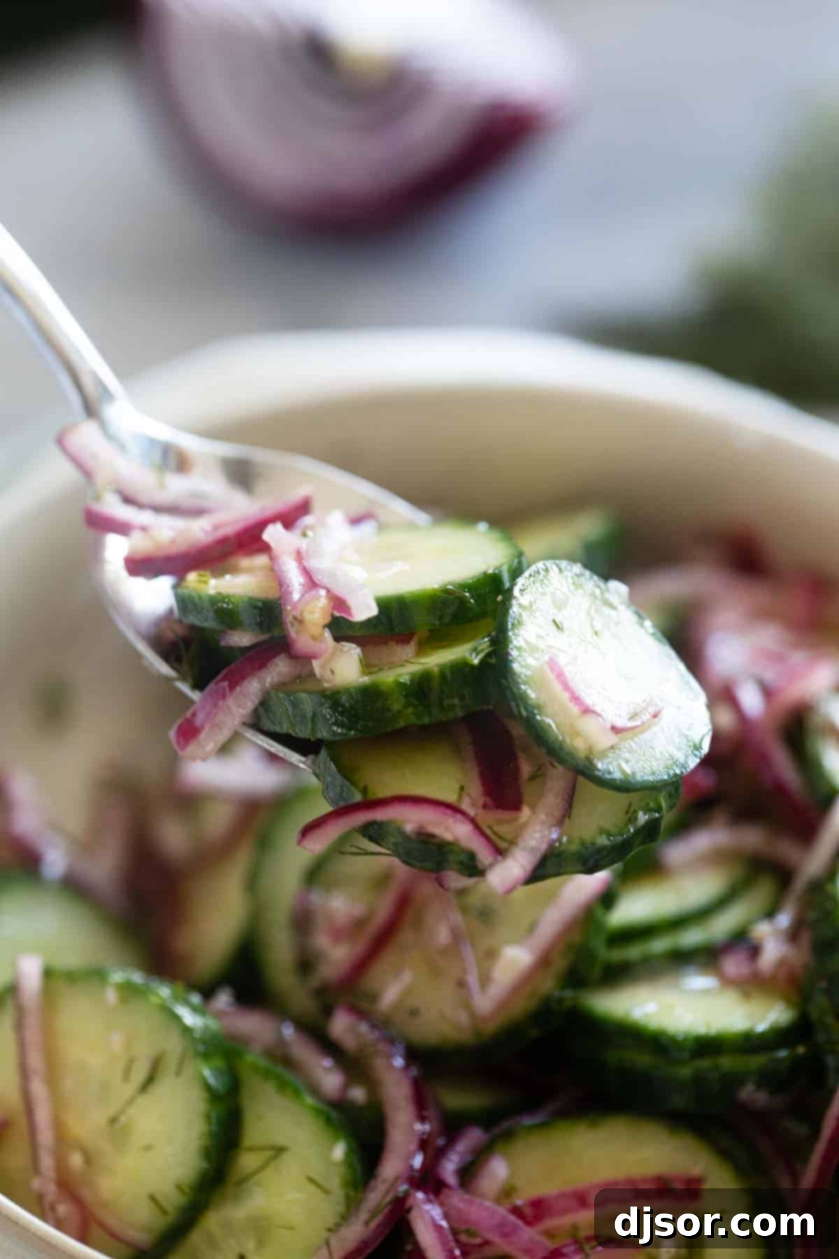 Refreshing Cucumber and Onion Salad 6 Cucumbers and onions on a fork.