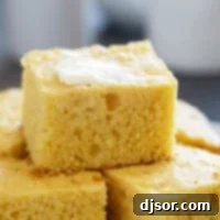 Slices of sour cream cornbread stacked on each other.