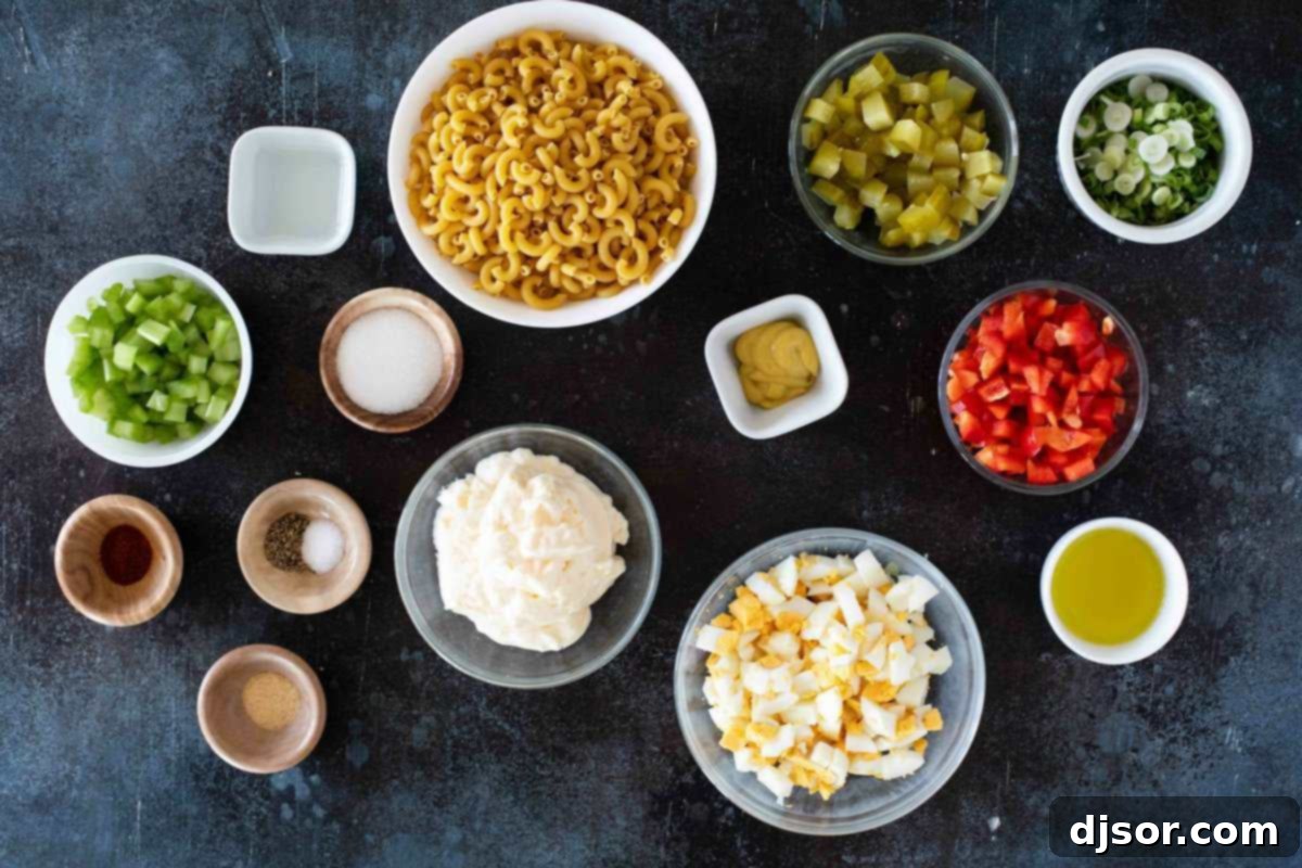 Creamy Macaroni Delight 3 A collection of fresh ingredients laid out for Macaroni Salad preparation, including pasta, vegetables, and condiments.
