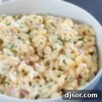 Creamy Macaroni Delight 8 Bowl filled with macaroni salad with celery, peppers, eggs, and more.