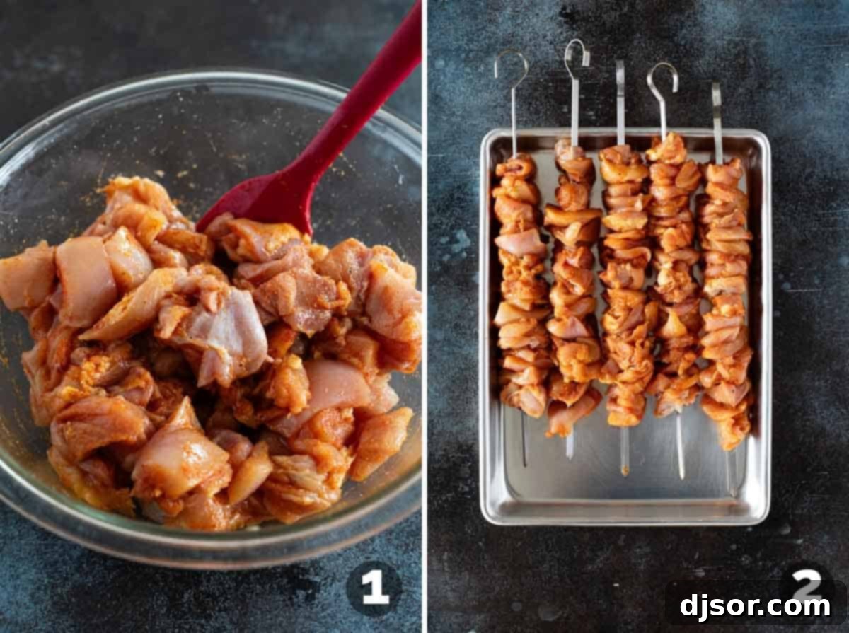 Ultimate Bang Bang Chicken Skewers 4 Seasoned chicken pieces being threaded onto metal skewers, ready for grilling.