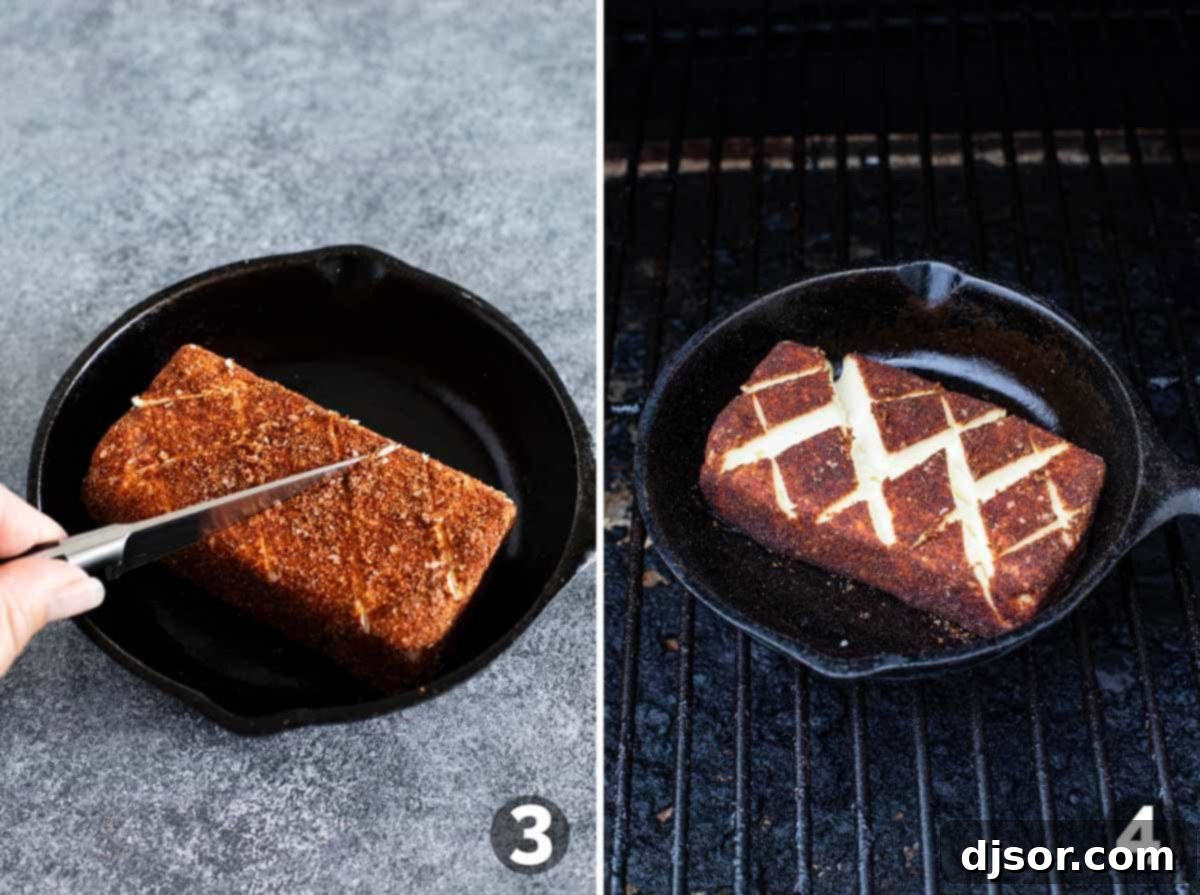 Scoring a block of seasoned cream cheese in a cast iron pan before placing it on a pellet grill for smoking.