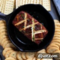 Smoked cream cheese in a cast iron dish, surrounded by crackers.