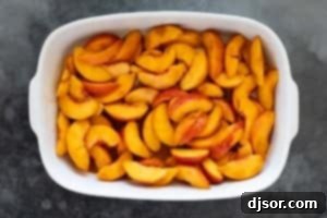 Peaches spread in a baking dish.
