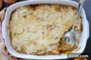 Cooked peach dump cake with a portion taken out.