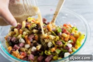 Adding dressing to Italian Pasta Salad.