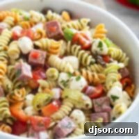 Bowl filled with Italian Pasta Salad with rotini pasta.