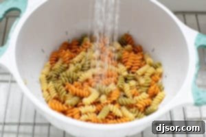 Rinsing cooked pasta for Italian Pasta Salad.