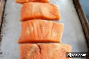 Seasoning salmon fillets.