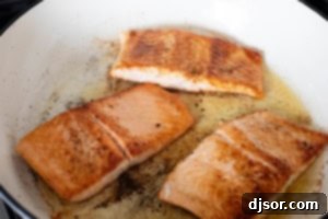 Cooking Tuscan Salmon in a skillet.