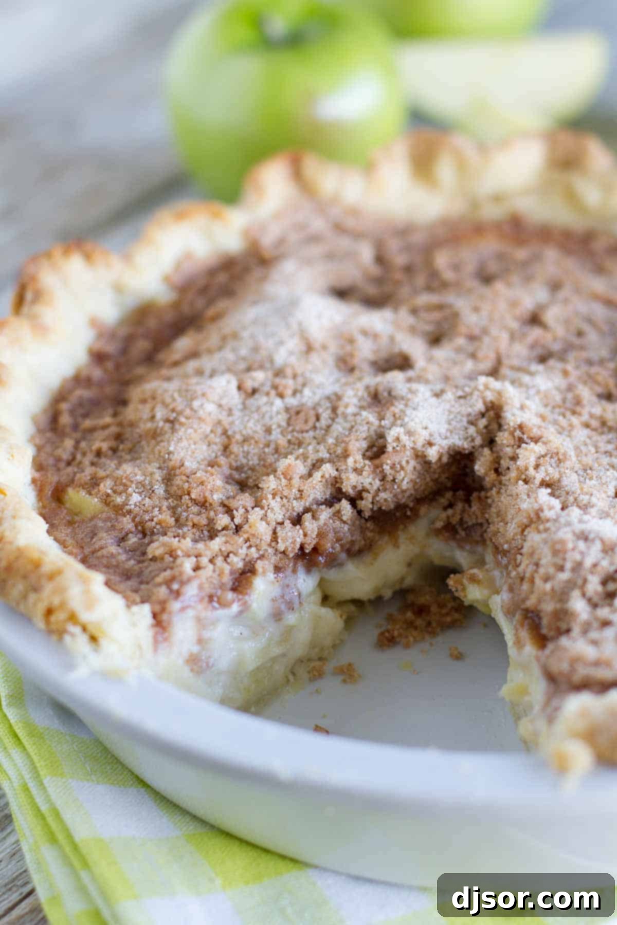 A Sour Cream Apple Pie with one slice removed, showcasing the delicious layers. Sour Cream Apple Pie with Slice Gone