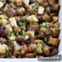 Festive Apple Cranberry Sausage Stuffing 2 A golden casserole dish of savory Sausage Stuffing with Apples and Cranberries, perfectly baked and ready for the holiday table.