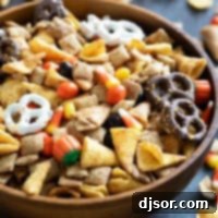 Monster Mash Mix 9 Wooden bowl filled with Halloween Chex mix.