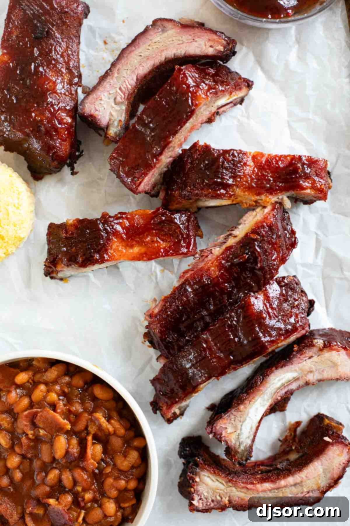 Slow-Smoked Ribs 8 Smoked Ribs with barbecue sauce, cut into individual ribs and stacked on a serving platter.