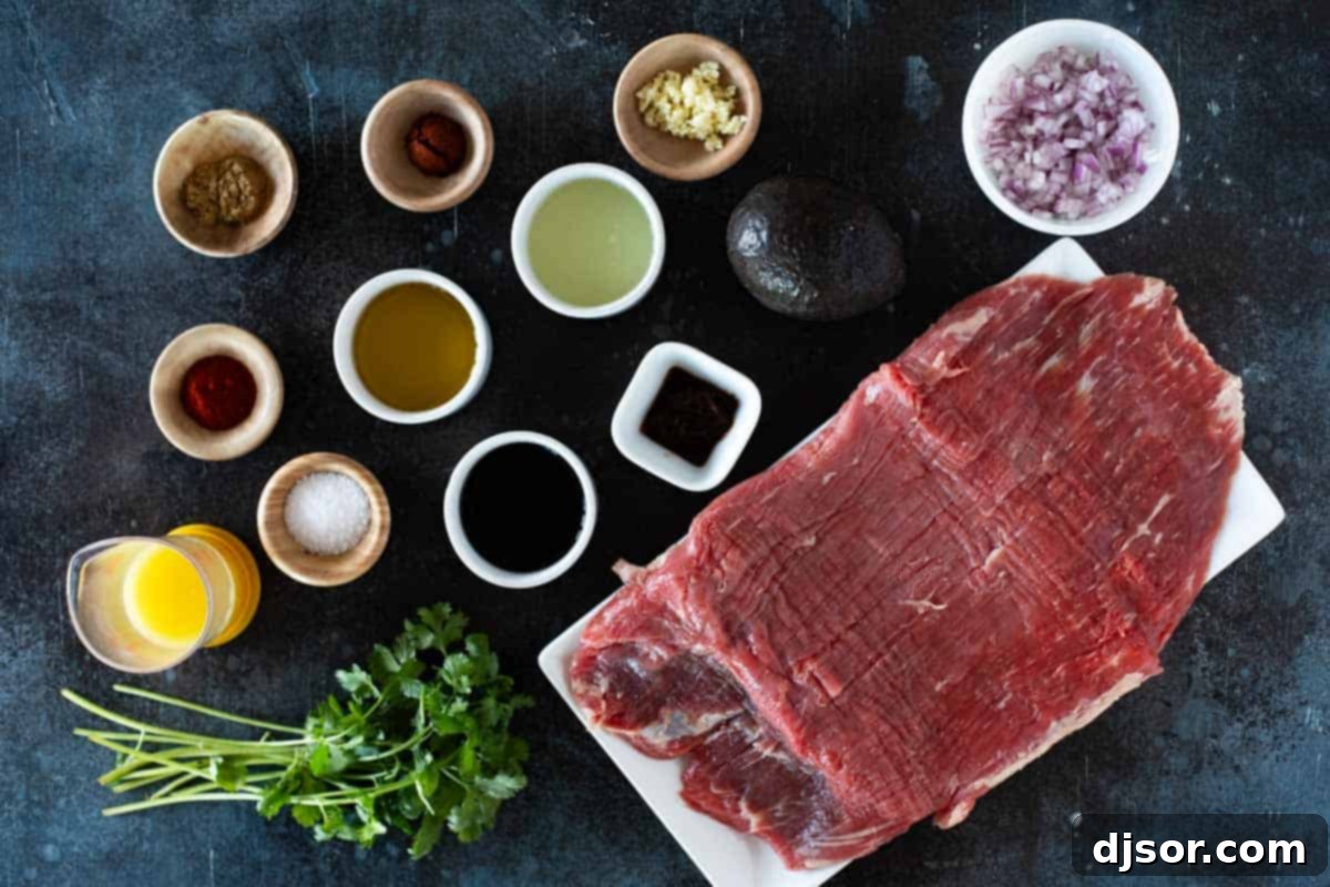Street Style Flank Steak Tacos 3 Ingredients for Flank Steak Tacos laid out on a cutting board, including fresh citrus, spices, and flank steak.