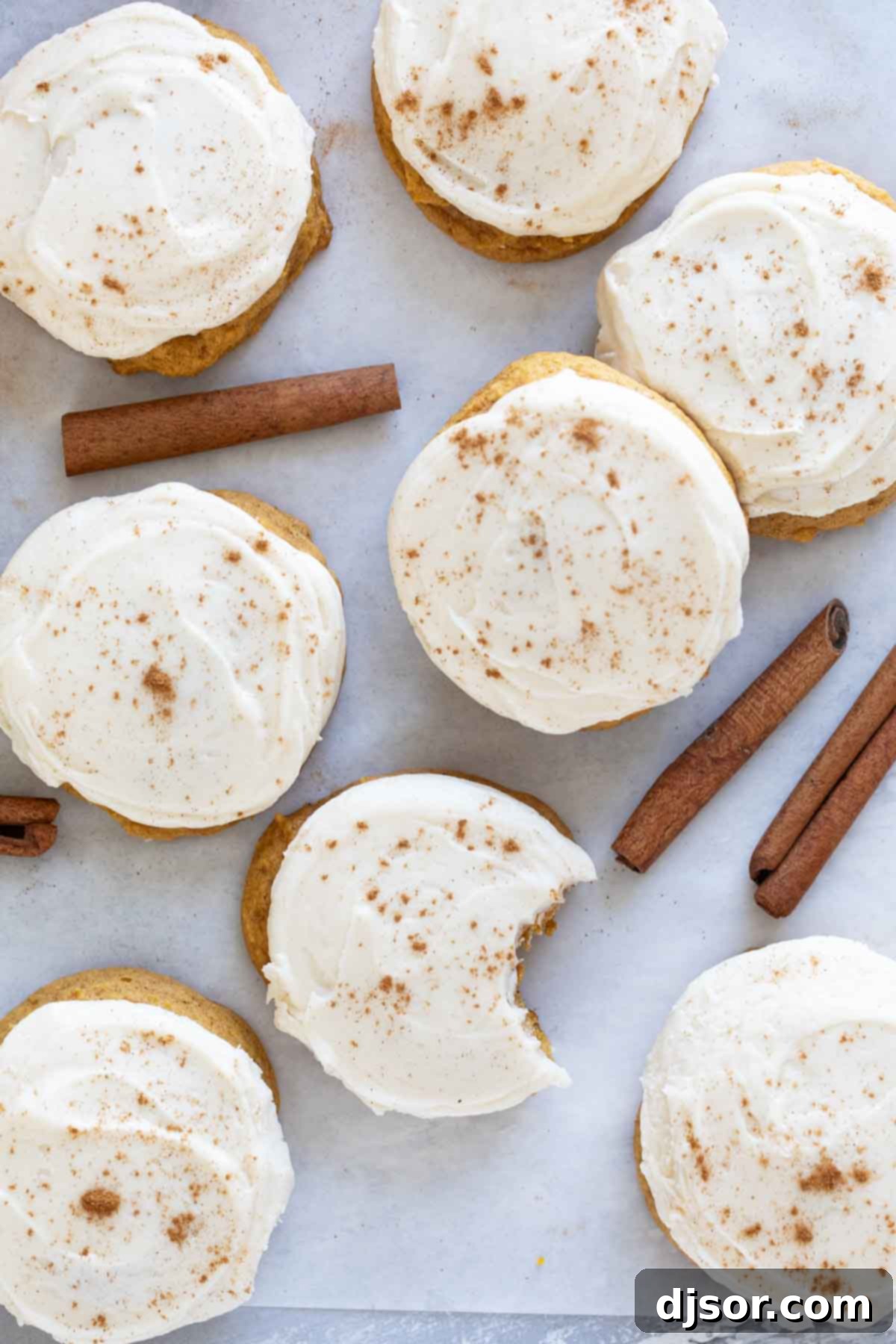 Cream Cheese Frosted Pumpkin Spice Cookies 7 Pumpkin Cookies with Cream Cheese Frosting with cinnamon dusted on top.