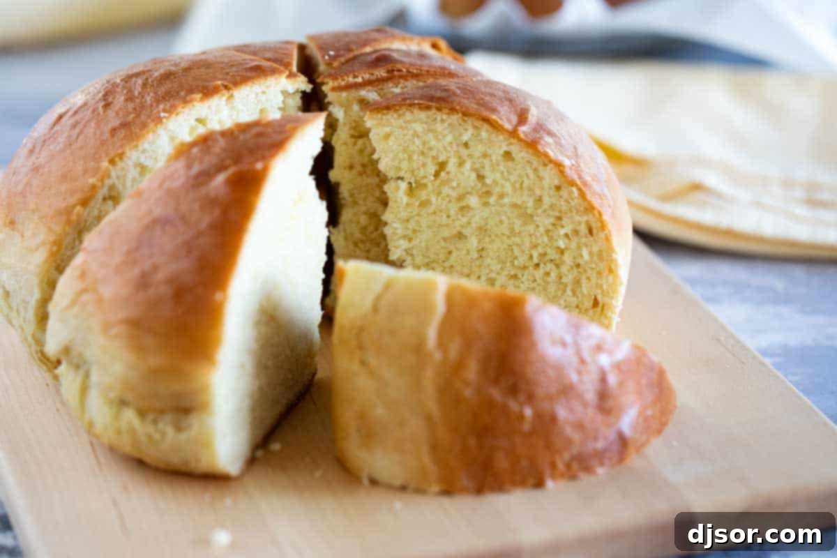 Soft and slightly sweet, this Hawaiian Bread is the perfect side dish to any Hawaiian meal. Serve it up as a side with butter, and save a loaf for French toast the next day! A beautifully baked loaf of Hawaiian Sweet Bread, sliced into wedges, showcasing its soft, fluffy interior and golden-brown crust.