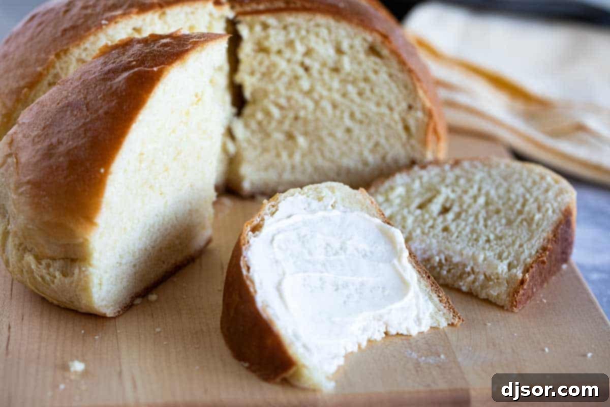 Soft and slightly sweet, this Hawaiian Bread is the perfect side dish to any Hawaiian meal. Serve it up as a side with butter, and save a loaf for French toast the next day! A single slice of fluffy Hawaiian Sweet Bread, topped with a melting pat of butter, ready to be enjoyed.