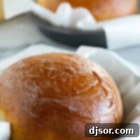 Aloha Sweet Loaf 2 Three round boules of Hawaiian Sweet Bread baked in parchment-lined cake pans, showcasing a delicious golden brown color.