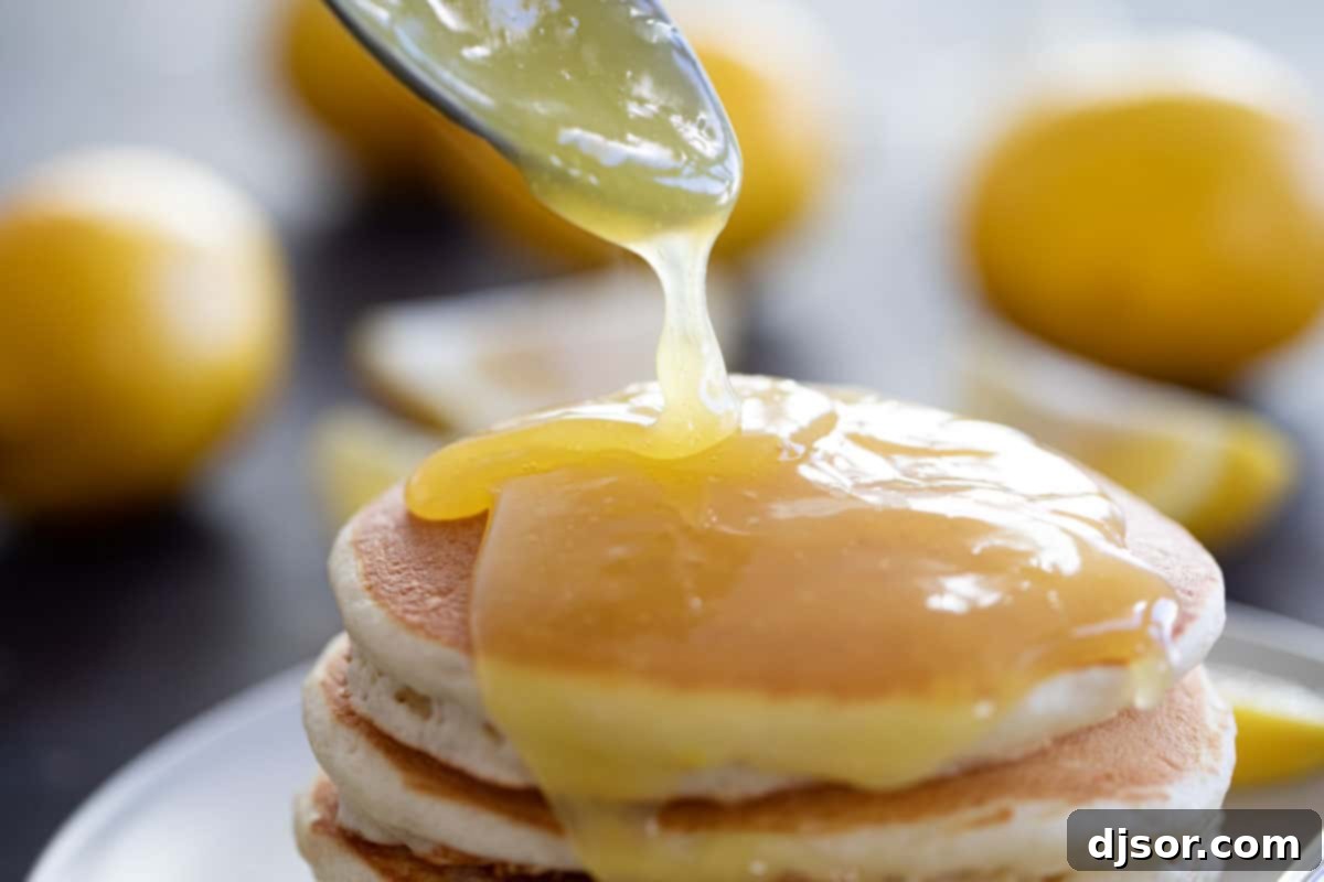 Delicious homemade lemon sauce in a bowl, perfect for enhancing your breakfast. Close-up of vibrant yellow lemon sauce in a rustic white bowl, ready to be served.