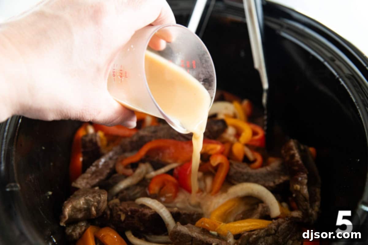 Fall-Apart Slow Cooker Pepper Steak 5 Pouring a cornstarch mixture into a crockpot for Slow Cooker Pepper Steak.