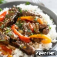 Fall-Apart Slow Cooker Pepper Steak 8 Serving of slow cooker pepper steak over rice, topped with cilantro and sesame seeds.