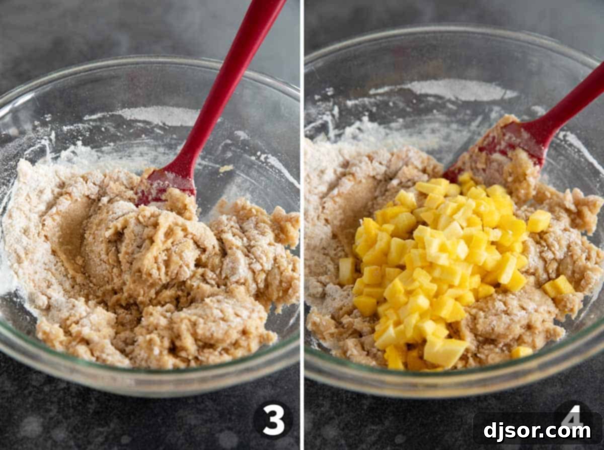Close-up of mango bread batter being mixed in a bowl with a spatula.