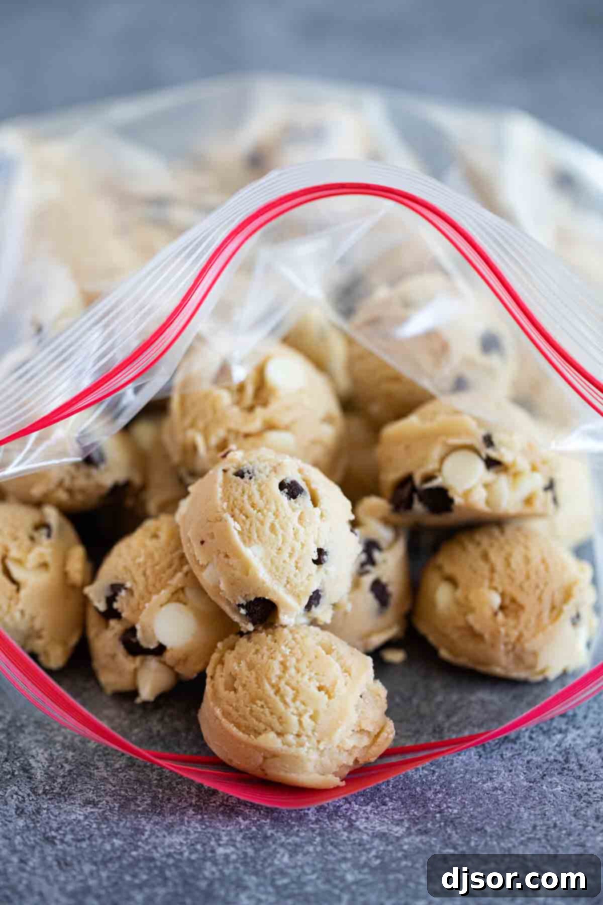 Ziplock bag filled with perfectly portioned frozen cookie dough balls, ready for baking.