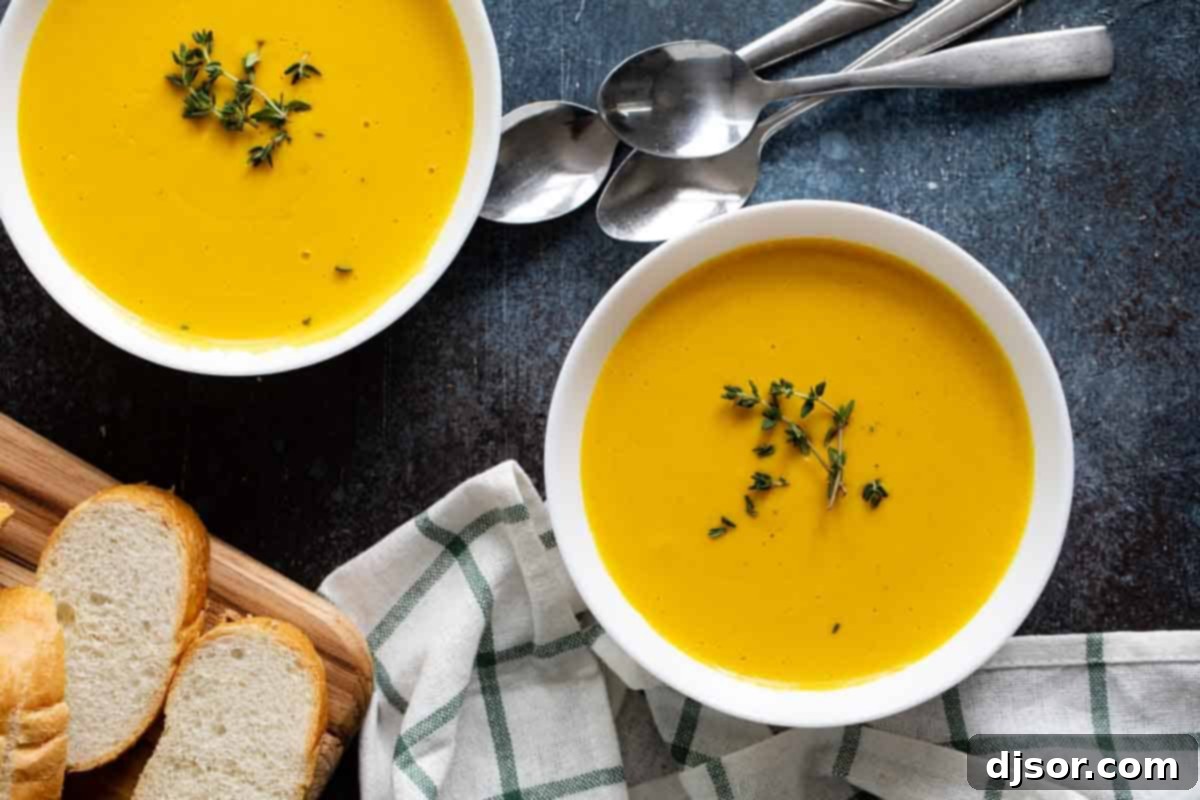 Overhead shot of a bowl of butternut squash soup, perfectly smooth and creamy, inviting a comforting meal.