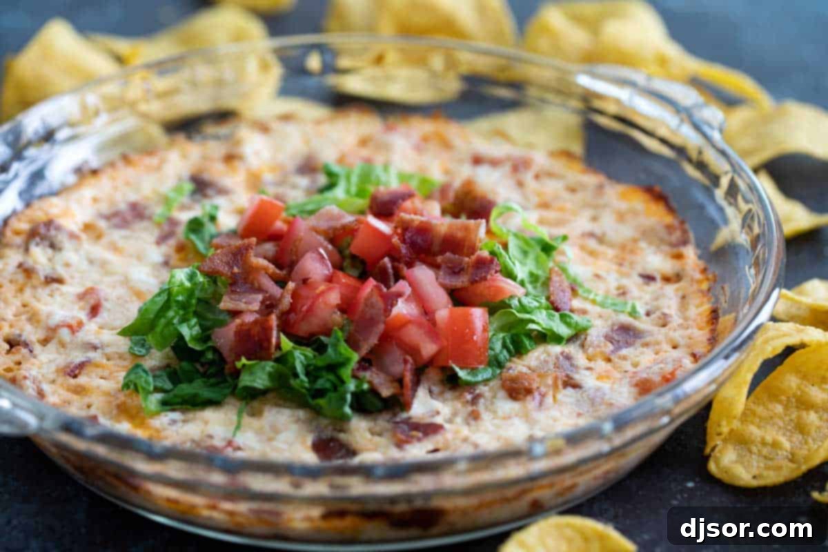 Easy Baked BLT Dip topped with lettuce and tomatoes