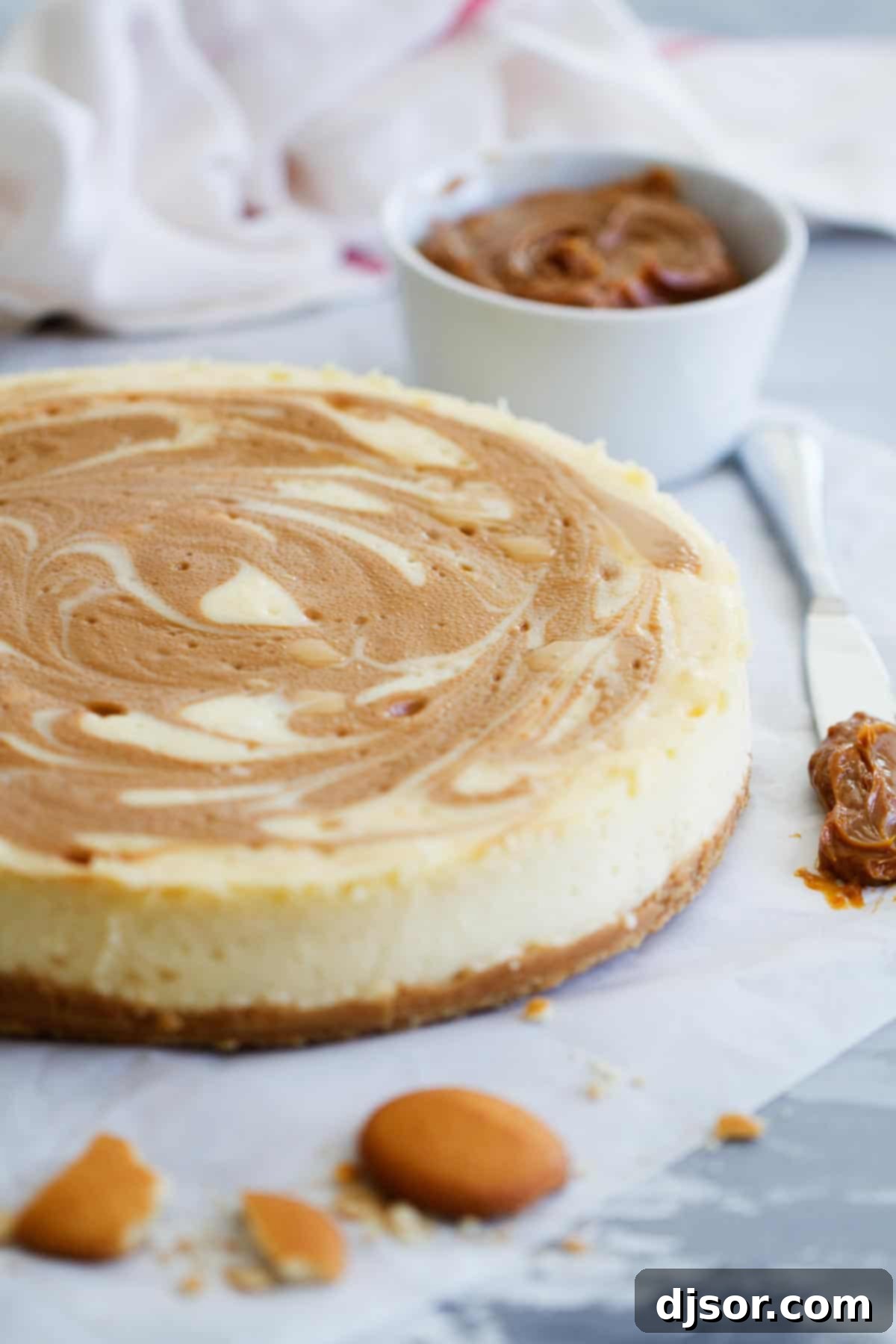 A creamy cheesecake is swirled with dulce de leche in this decadent and delicious Dulce de Leche Cheesecake. This creamy cheesecake is holiday worthy! Full Dulce de Leche Cheesecake, perfectly baked and chilled, ready to be served.