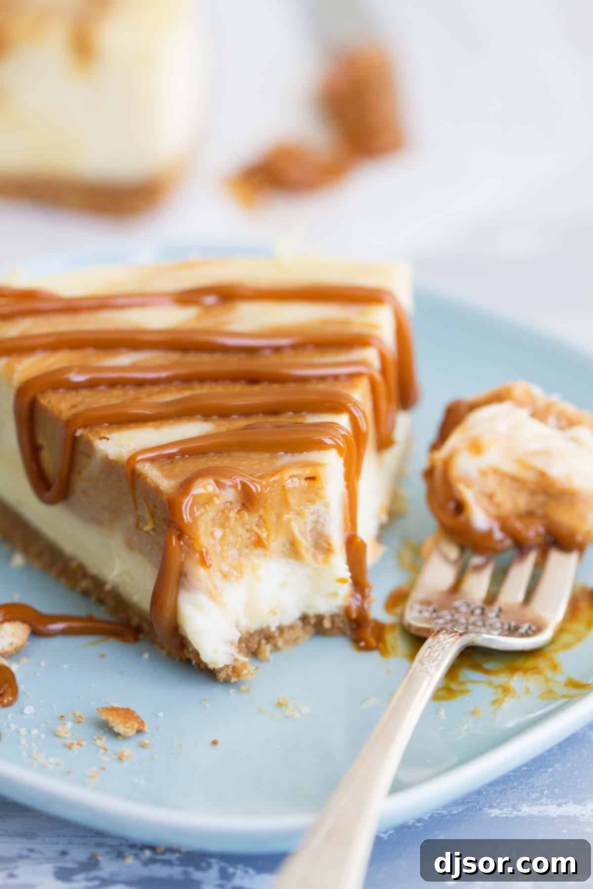 A delicious slice of Dulce de Leche Cheesecake with a bite taken out, showing its creamy interior and distinct crust.