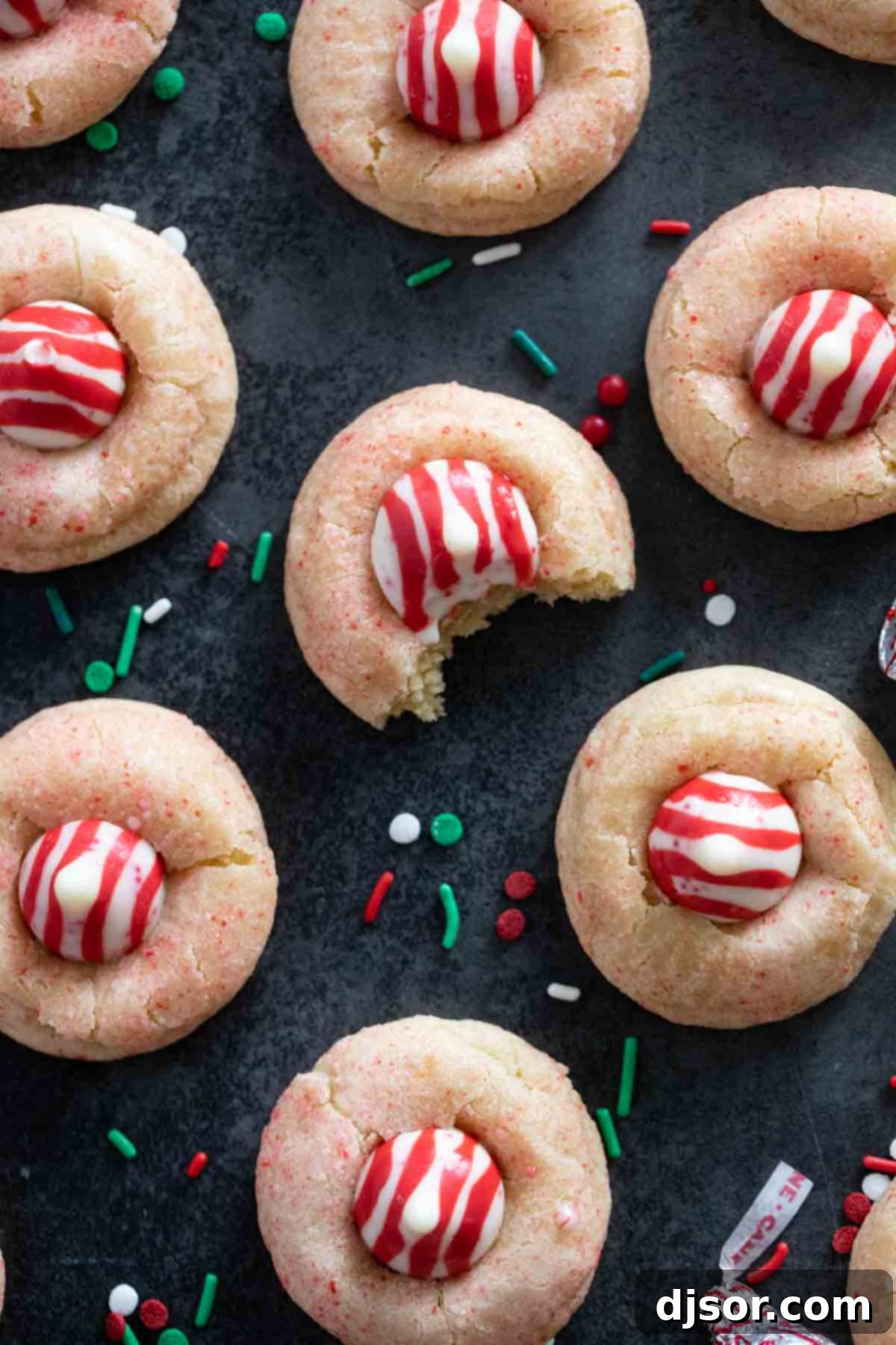 A festive platter of Peppermint Kiss Cookies, some with a bite taken from them.