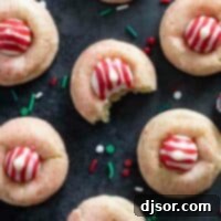 Peppermint Kiss Cookies with a bite taken from one of the cookies.