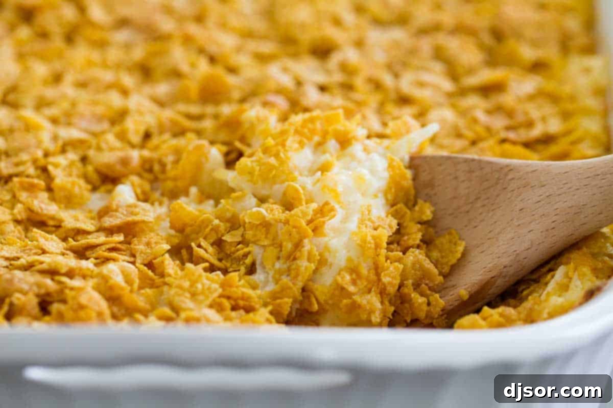 dish of funeral potatoes with wooden spoon