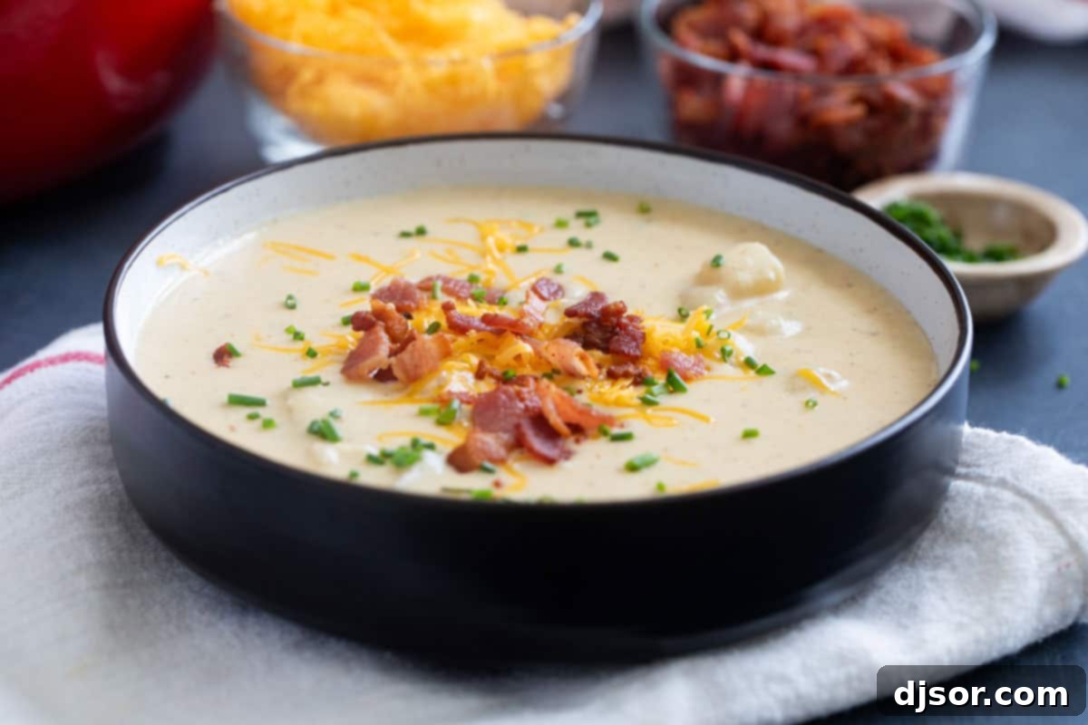 Loaded Baked Potato Soup 2 Bowl full of baked potato soup, topped with cheese and bacon.