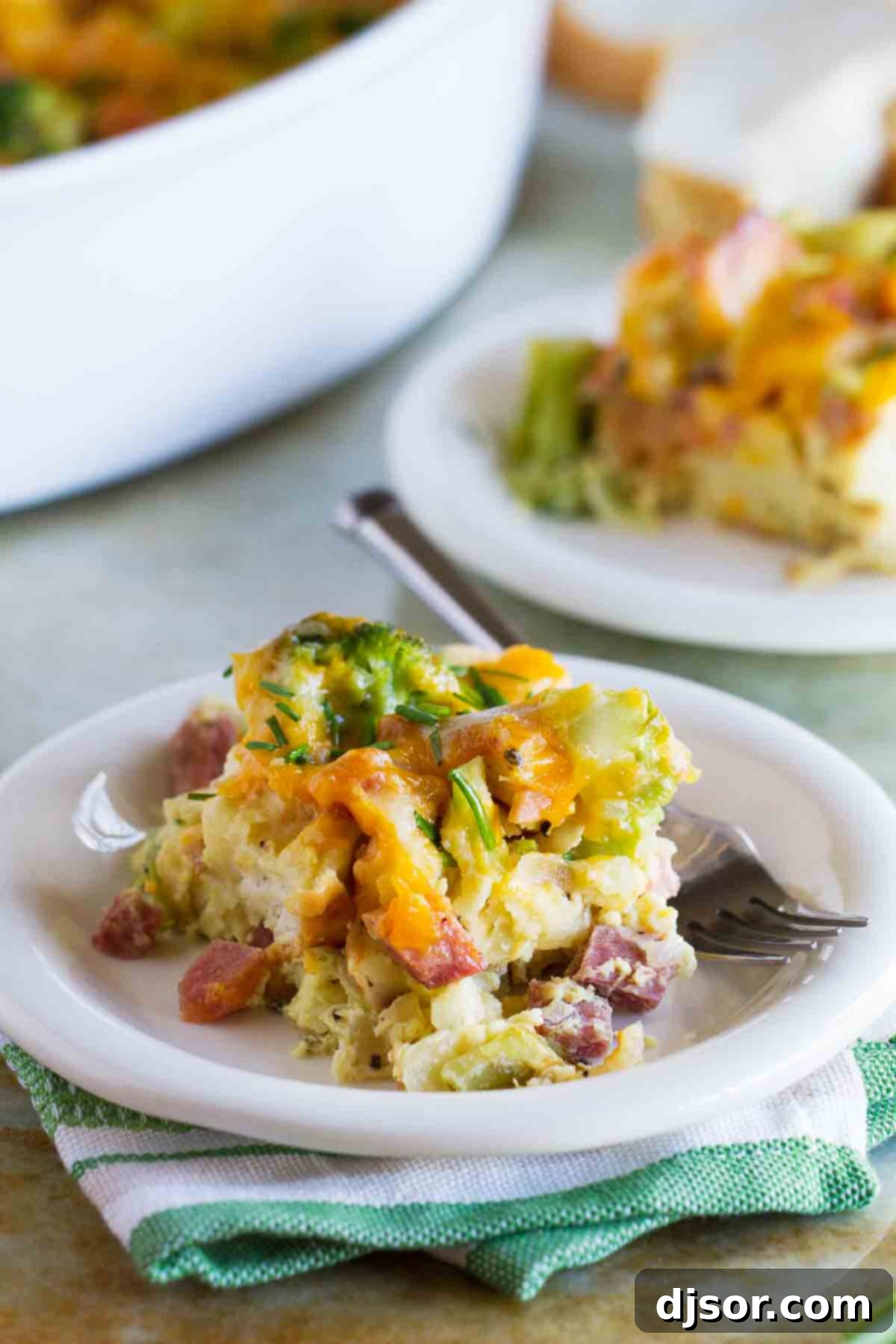 Hearty Ham, Cheese, and Broccoli Bake 2 A generous serving of Ham and Cheese Strata with Broccoli on a small white plate, ready to be enjoyed.