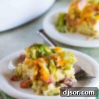 Hearty Ham, Cheese, and Broccoli Bake 5 Close-up of a serving of Ham and Cheese Strata with Broccoli, highlighting the rich cheese and tender components.