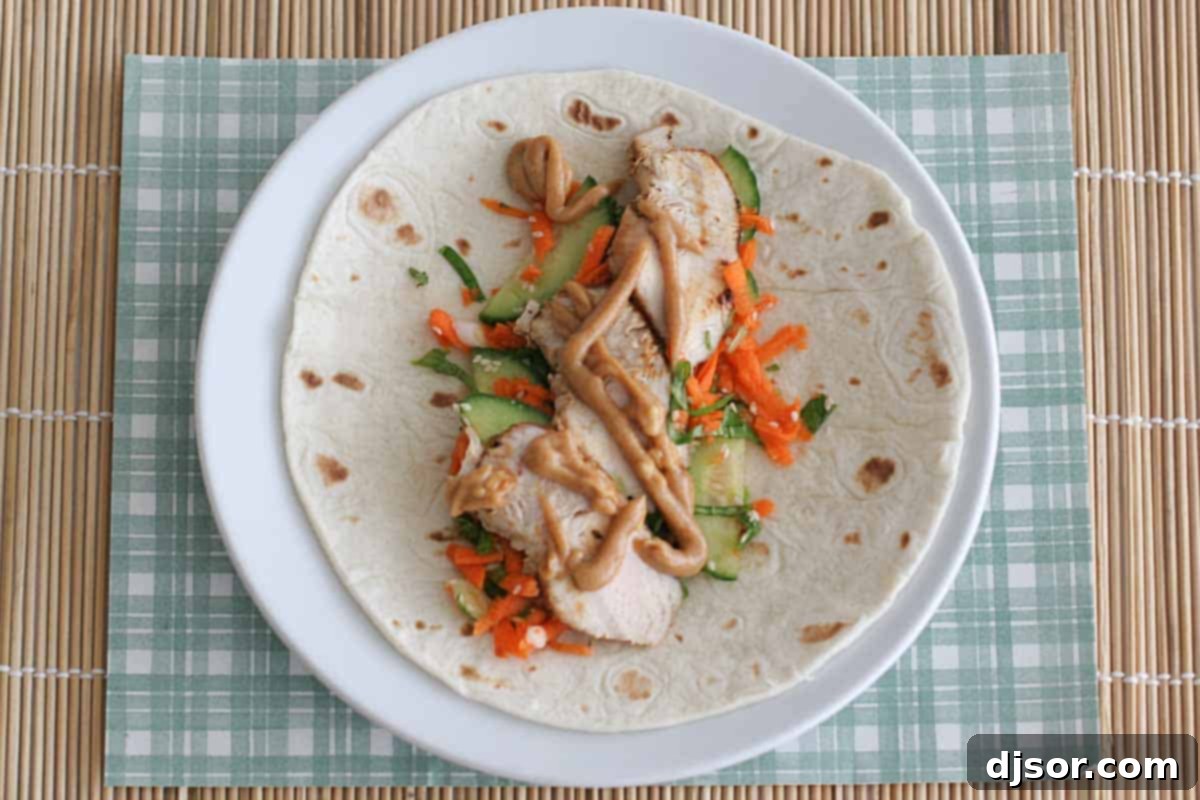 Open Thai Chicken Wrap with Spicy Peanut Sauce showcasing fresh ingredients