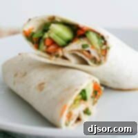 Thai Chicken Wrap cut in half and stacked on a plate