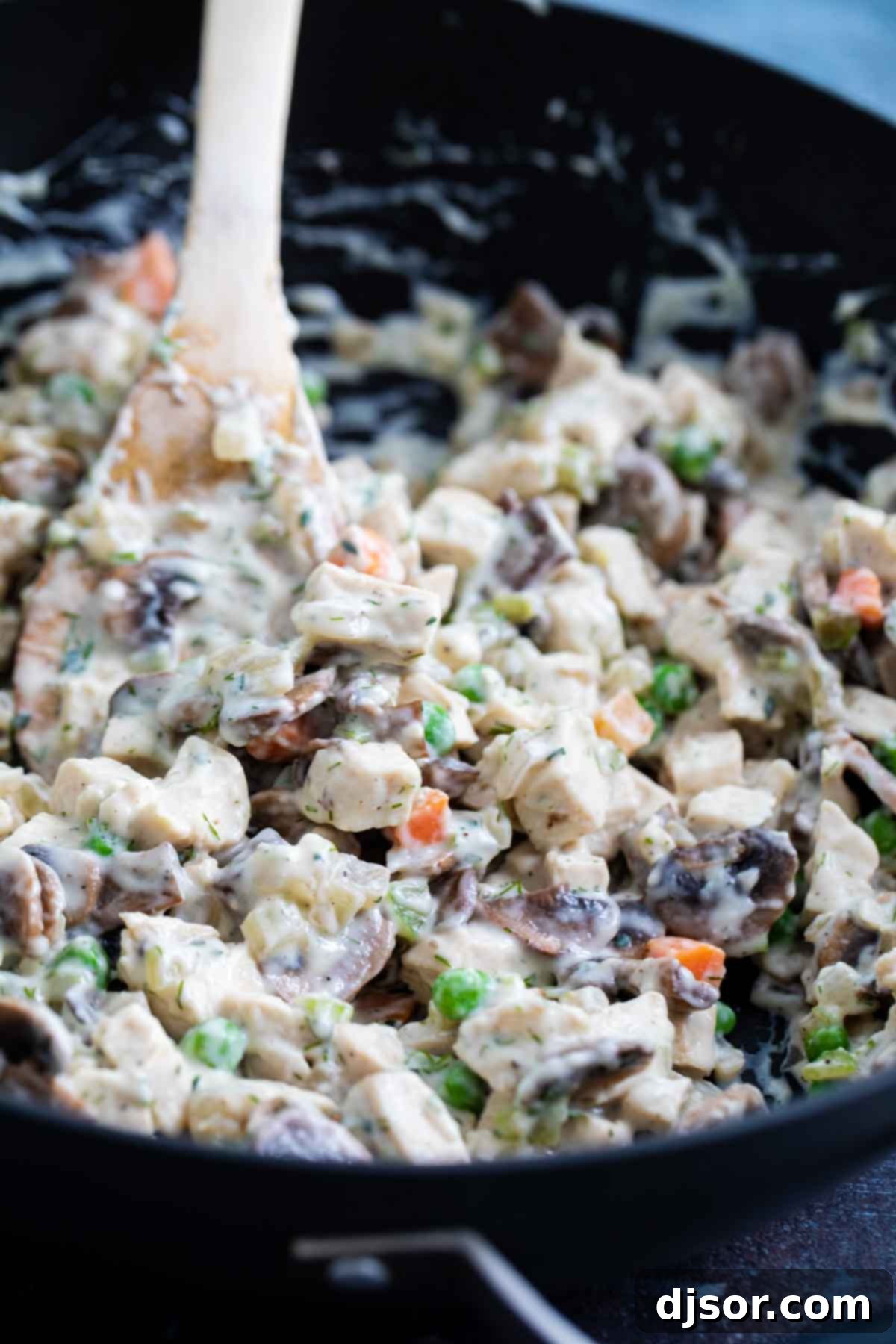 Creamy filling for chicken pot pies in a skillet.