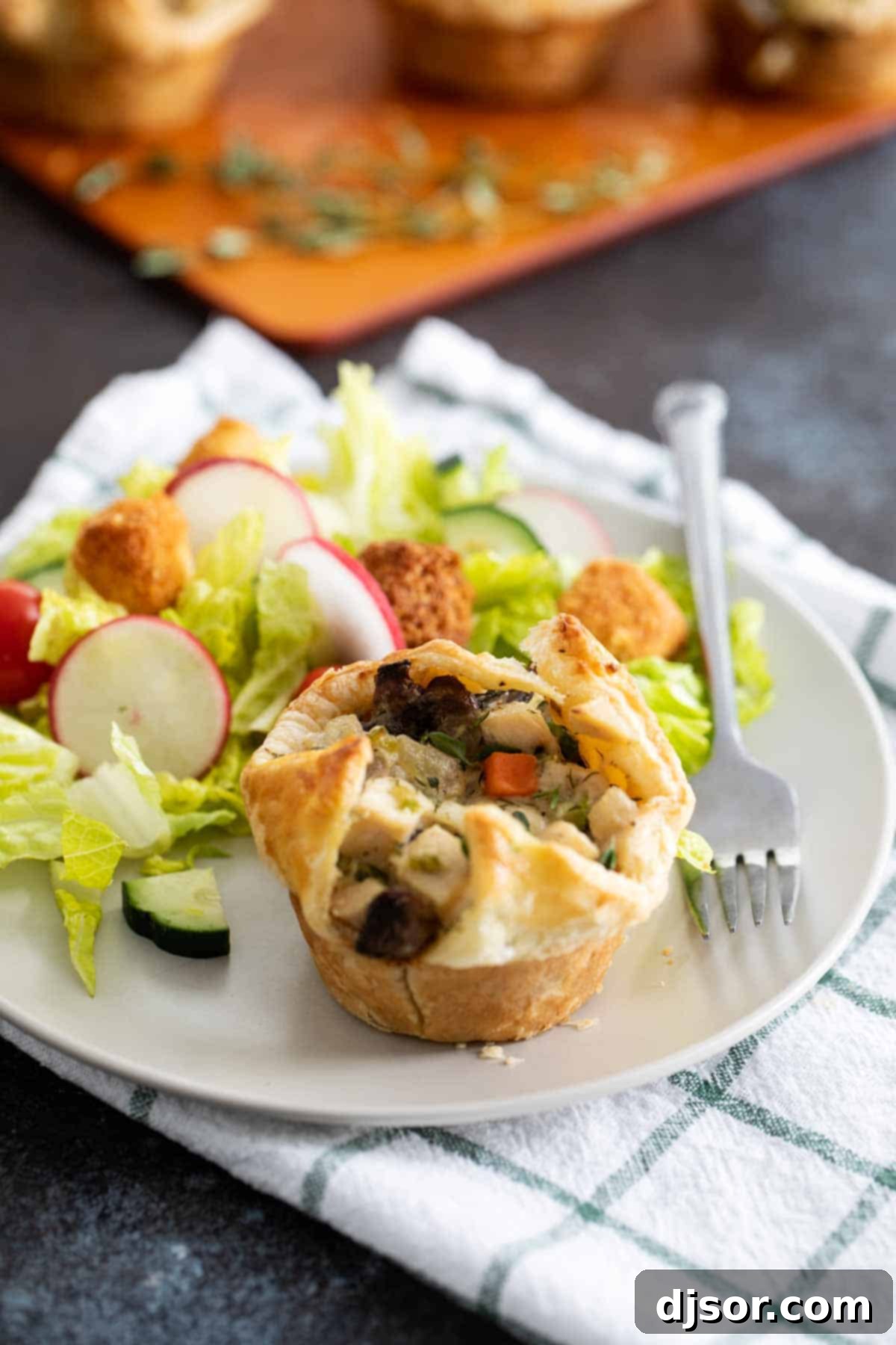 Muffin Tin Chicken Pot Pie served with a fresh green salad.