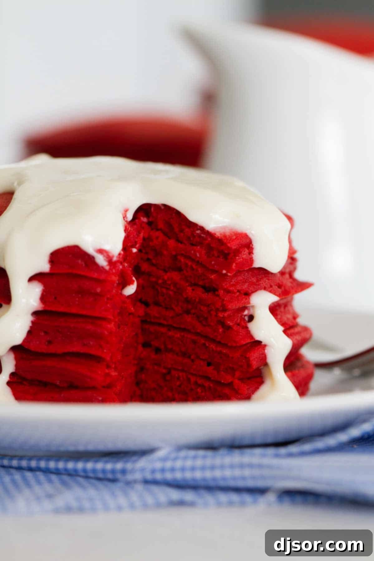 Fluffy Red Velvet Pancake Interior A close-up internal view of a Red Velvet Pancake torn open, revealing its incredibly light, airy, and fluffy texture. The vibrant red crumb is visible, showcasing the pancake's soft interior and promising a delightful bite.