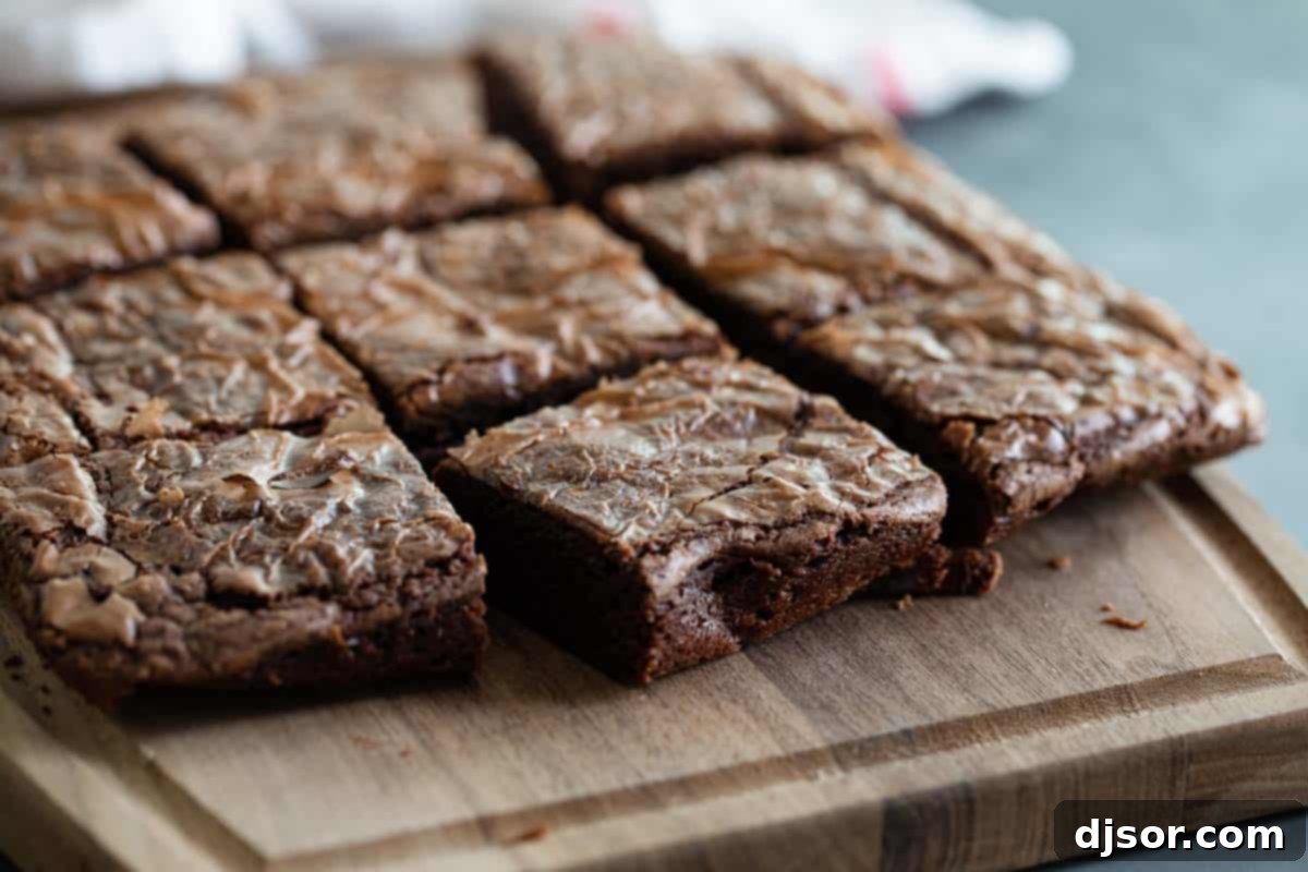 Perfectly sliced fudgy Nutella brownies arranged on a wooden cutting board, showcasing their rich texture and tempting appeal.