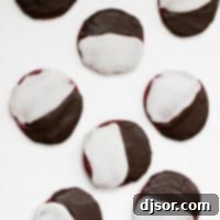 Elegant Red Velvet Black and White Cookies 4 Red velvet black and white cookies on a white background.