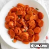 Sweet and Sticky Glazed Carrots 2 overhead view of glazed carrots in a white bowl